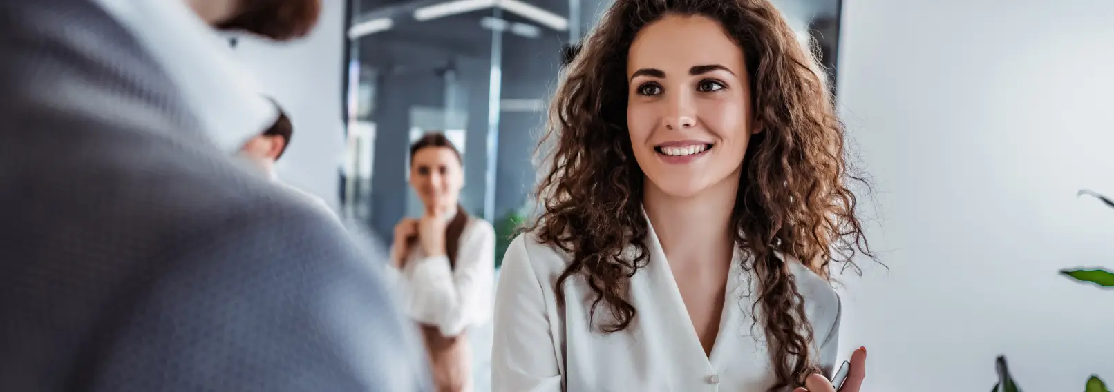 Professional banker with a notebook in hand meeting a client for a meeting.