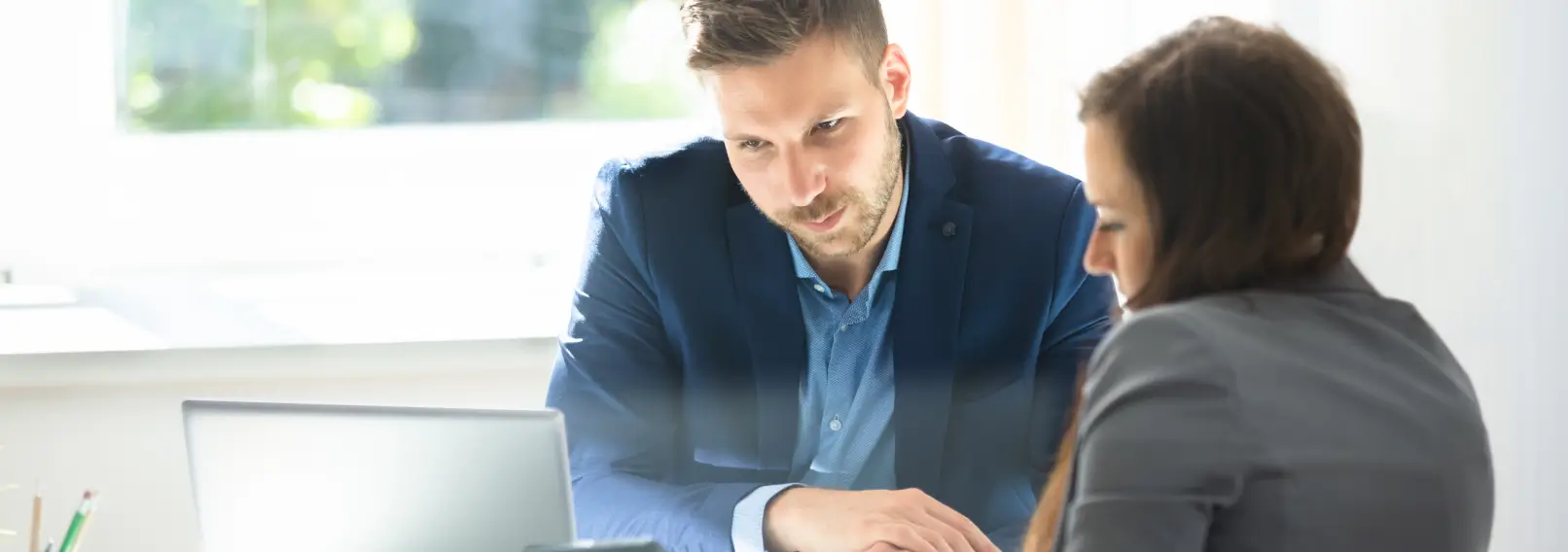 Serious business man looking at a document with a coworker.