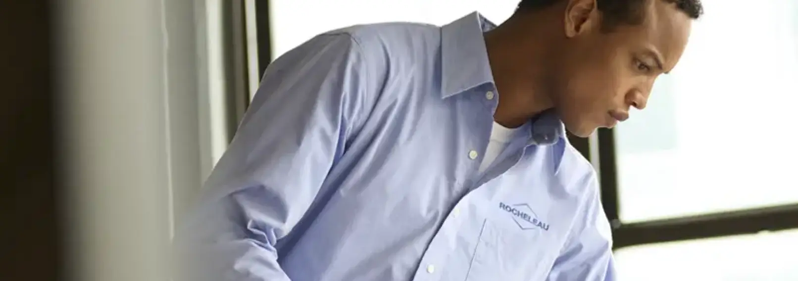 Professional wearing a blue company uniform shirt