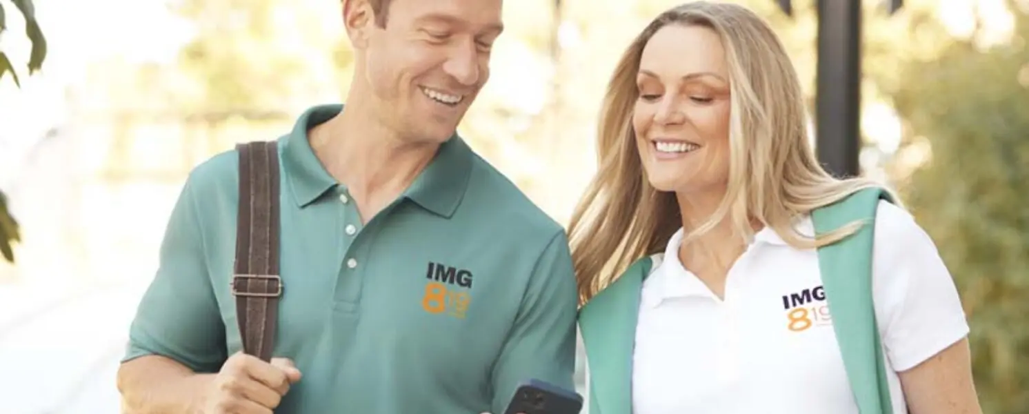 Man and woman wearing green and white spring business uniforms