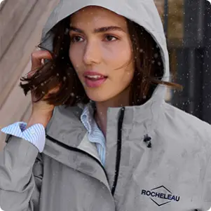 A woman wearing a gray jacket.
