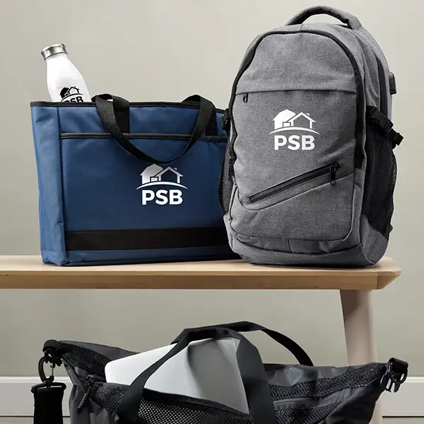 A navy tote and a gray backpack.