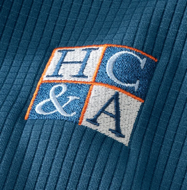 Logo monogrammed on blue sweater