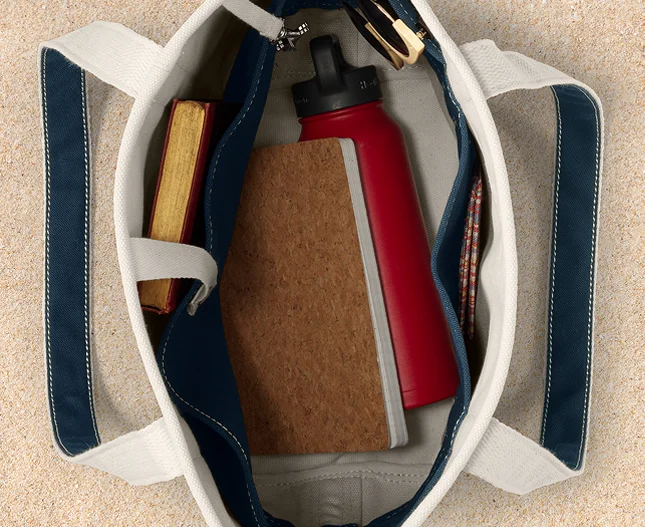 Canvas tote filled with work materials and accessories