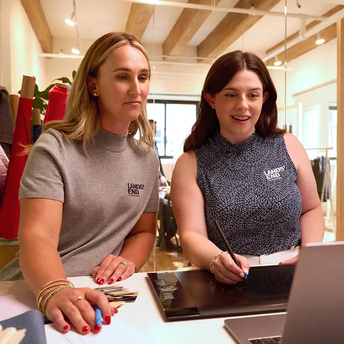 Designers working on custom product on a digital tablet.