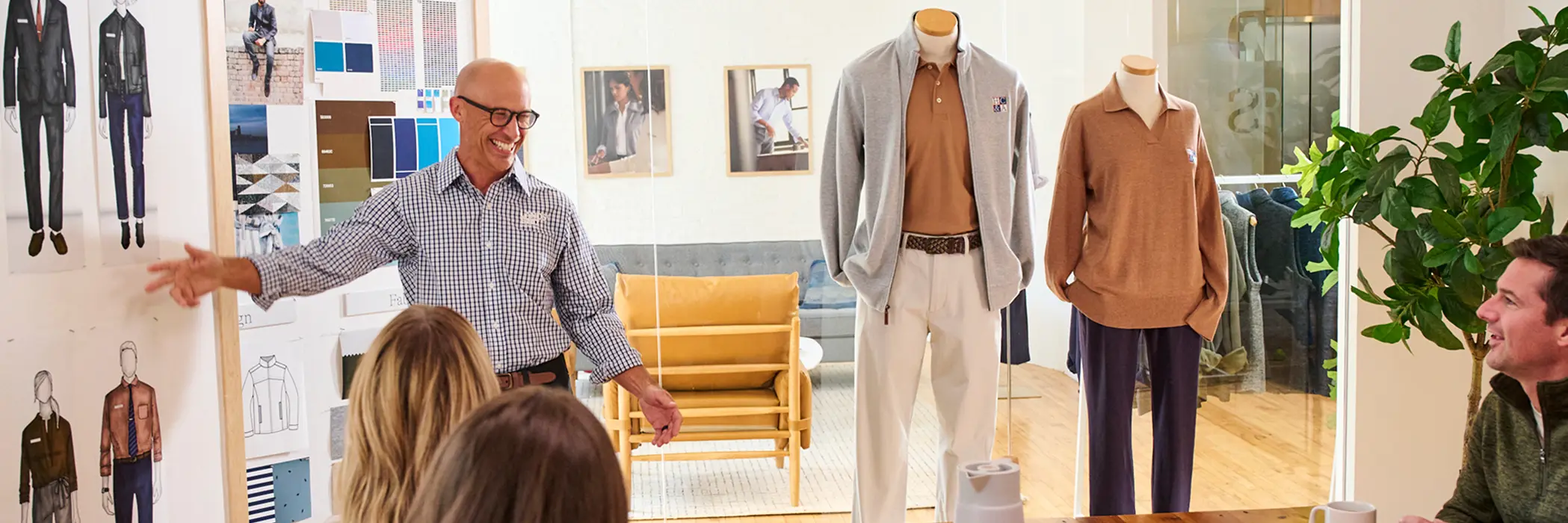 A designer presenting custom uniforms to a client.