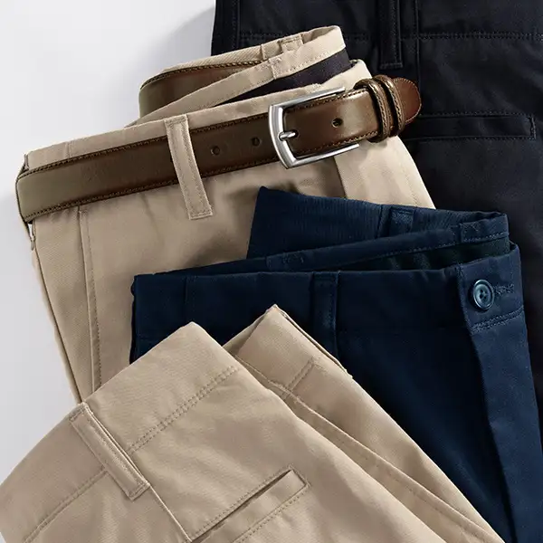 Several pairs of khaki and navy pants laying ontop of each other.