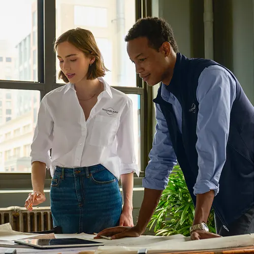 Two employees reviewing documents.