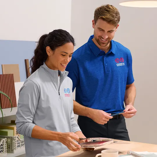Two employees reviewing work notes.