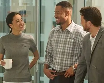 A group of employees chatting in an office.