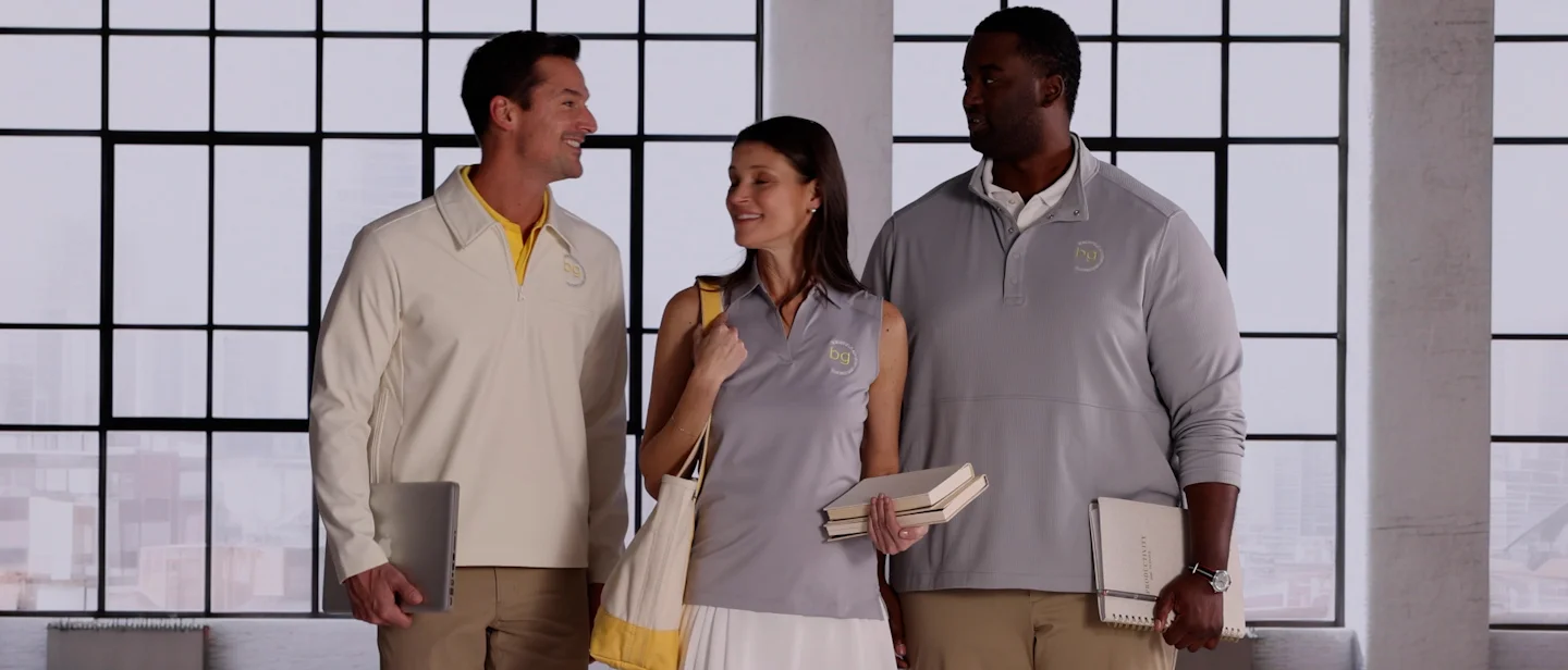 Employees wearing embroidered gray apparel.