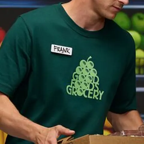 Mid chest logo placement on a dark green t-shirt.
