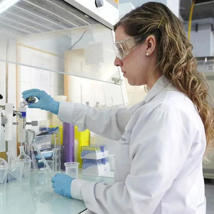 A lab technician testing chemicals.