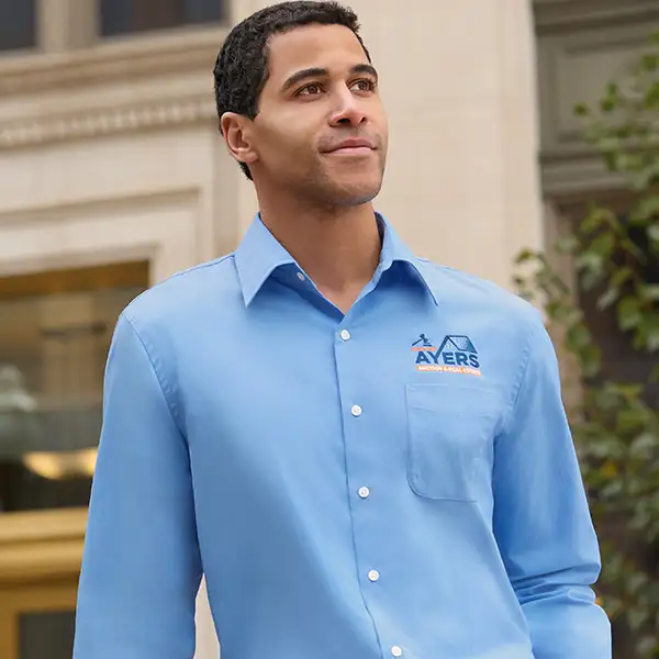 A man wearing a light blue casual shirt.