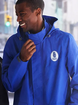 Man wearing a blue monogrammed outrigger jacket.
