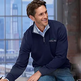 A man wearing a navy quarter zip pullover jacket.