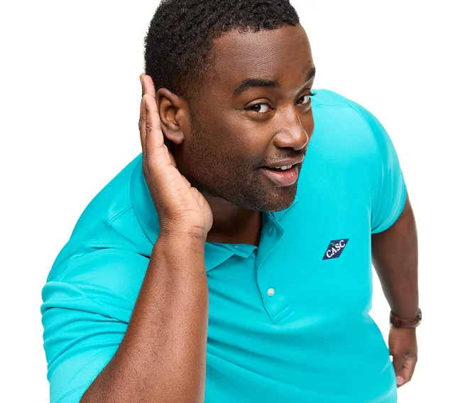 Man wearing a teal flagship performance polo.