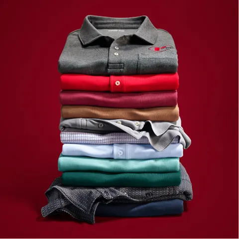 A stack of folded polos in different colors.