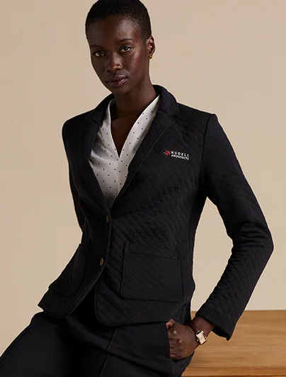 Woman wearing a black quilted 2-button blazer