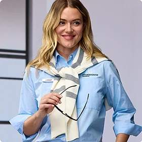 A woman wearing a blue shirt and scarf.