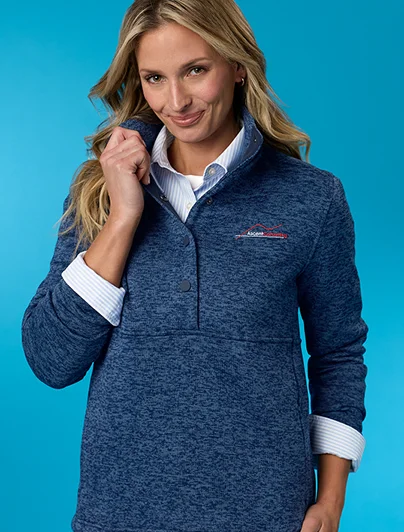 Woman wearing a blue sweater fleece snap neck pullover