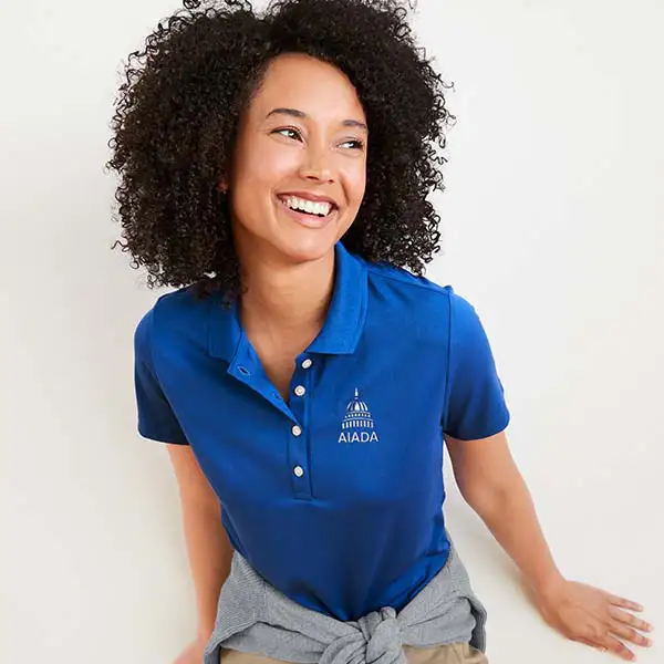 A woman wearing a cobalt blue polo.