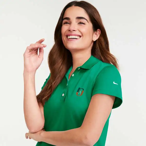 A woman wearing a green Nike polo.