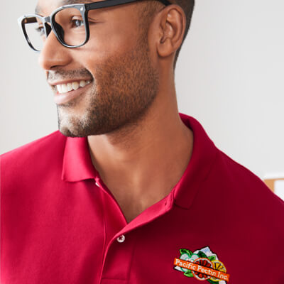 A person wearing an embroidered red polo.