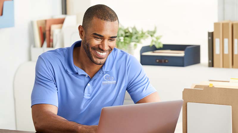 A man working at a laptop.